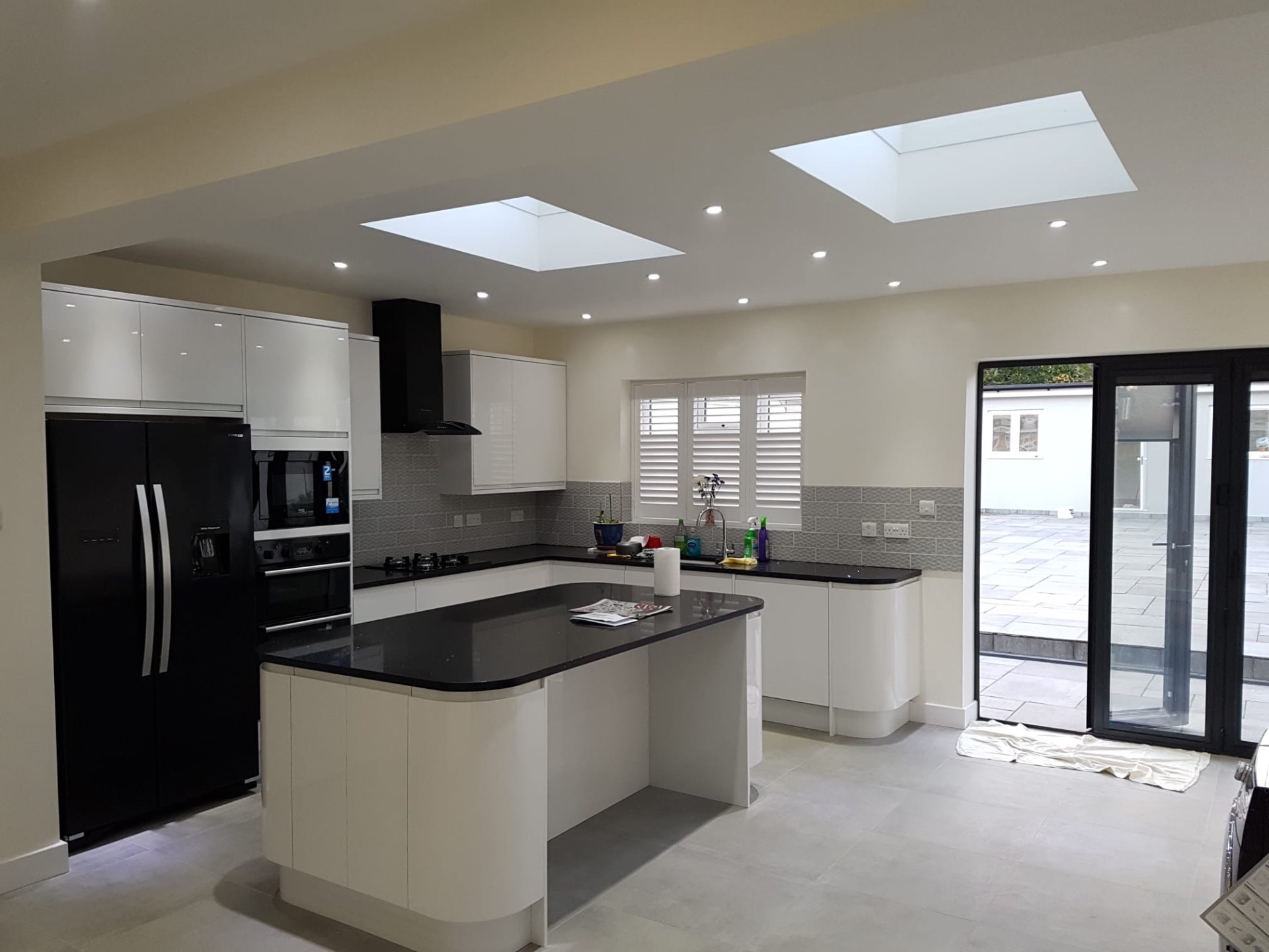 Kitchen extension with exposed London stock brick feature wall and crittall-style doors onto the garden